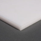 White polypropylene sheet corner shot from above on grey, showing the slab depth at the edge