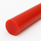 Close-up of an orange-red polyurethane rod on white, matt cut end at the lower left