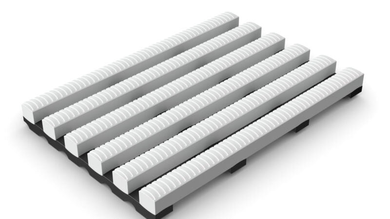 White modular High-Traffic Pool and Wet Areas Safety Mat section, featuring wide, raised ribs and open drainage channels for continuous water flow.