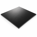 Black acetal sheet, angled studio shot showing textured surface on white background