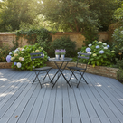 Mid grey anti-slip decking paint on a UK garden decking area with a bistro table and chairs