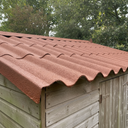 Rustic red asbestos roof paint on a corrugated cement shed roof in the UK