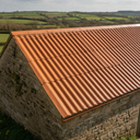 Terracotta asbestos roof paint on a cement tile-profile cottage outbuilding roof in the UK
