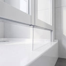 Clear extra tall blade seal hanging from a bifold screen rail down onto the edge of a white tray