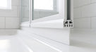 White seal running along the bottom rail of a white bifold bath screen, ridged cut end and blade flat on the bath