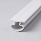 White PVC seal on white, flat top cap above a hollow rounded chamber, viewed along its length