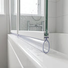 Clear seal under a white bath screen rail, its hollow oval loop outlined in blue against the white bath