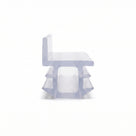 Clear seal cut piece end-on on white, chair-shaped with an upright back over a barbed hollow foot