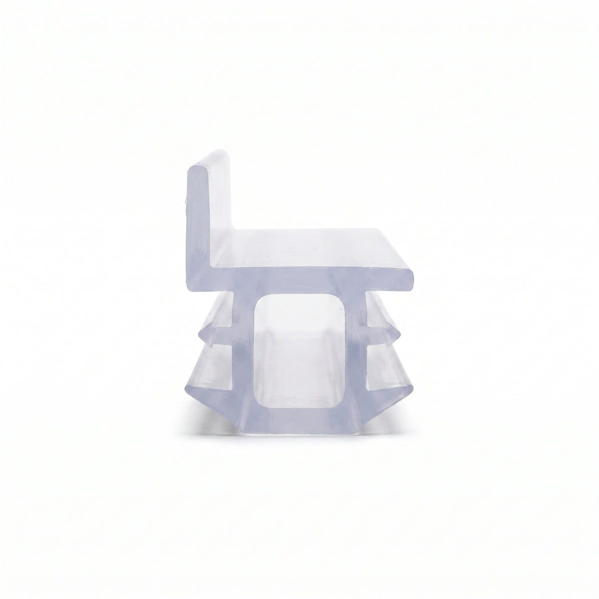 Clear seal cut piece end-on on white, chair-shaped with an upright back over a barbed hollow foot