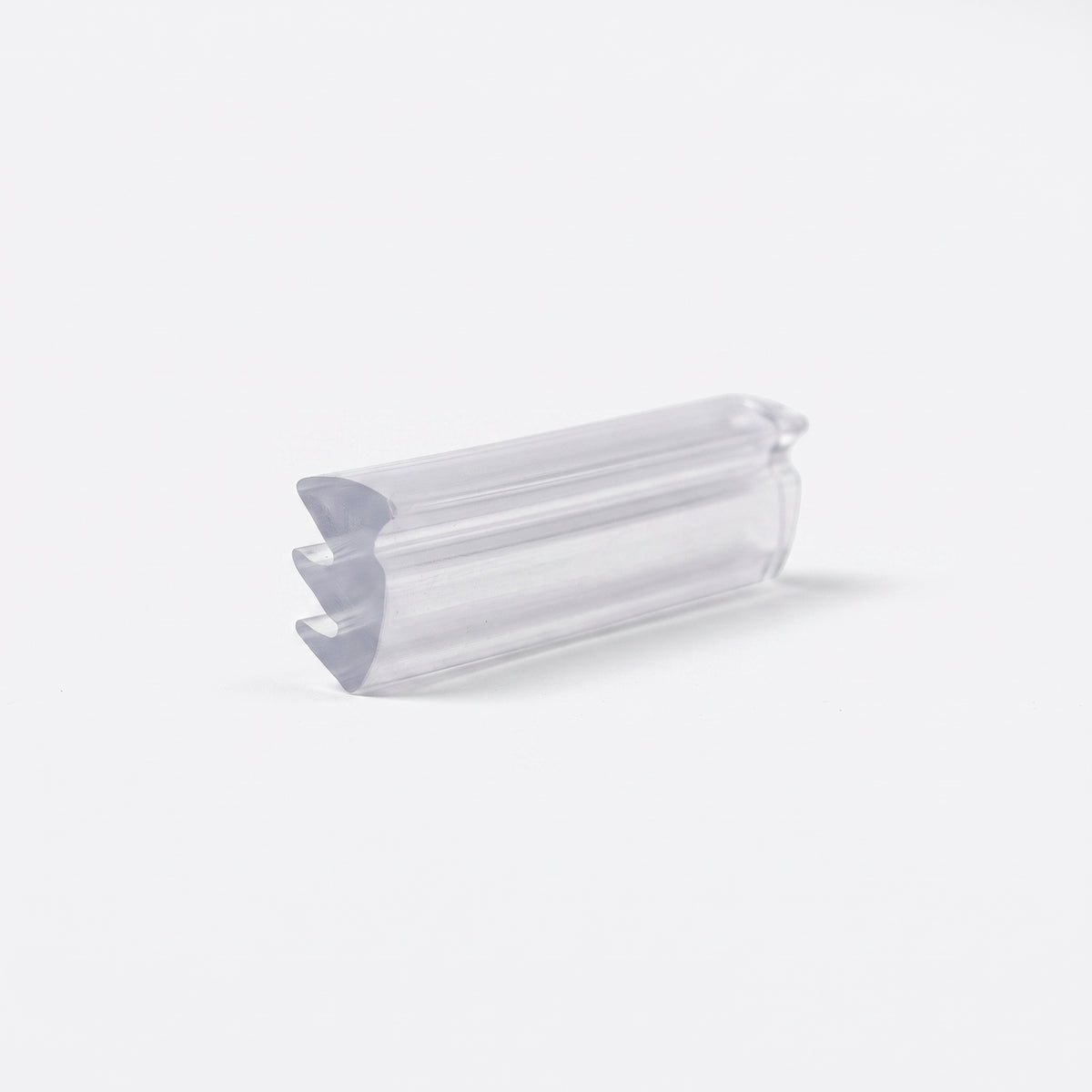 Clear wedge seal offcut angled on white, three stepped barb teeth running down one side