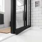 Black 4mm T-head channel seal fitted in a black-framed bifold shower door bottom rail, blade sealing to the tray