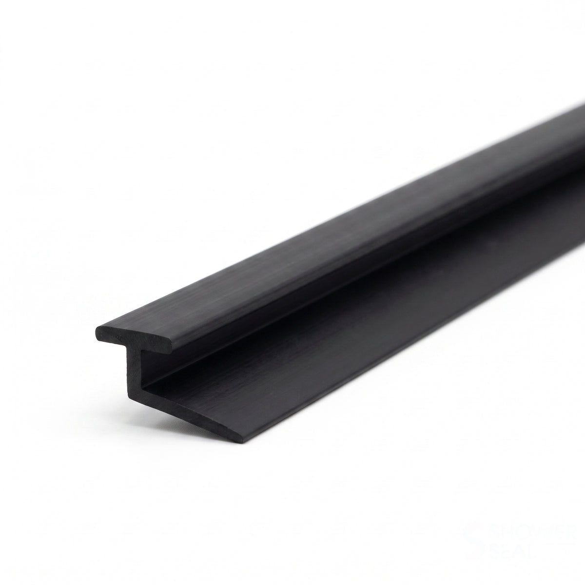 Long black seal extrusion on white, T-rib on top with a flat blade angling off one side