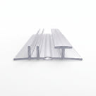 Clear bifold seal extrusion on white, wide flat base with a central twin-wall channel and T-head fin