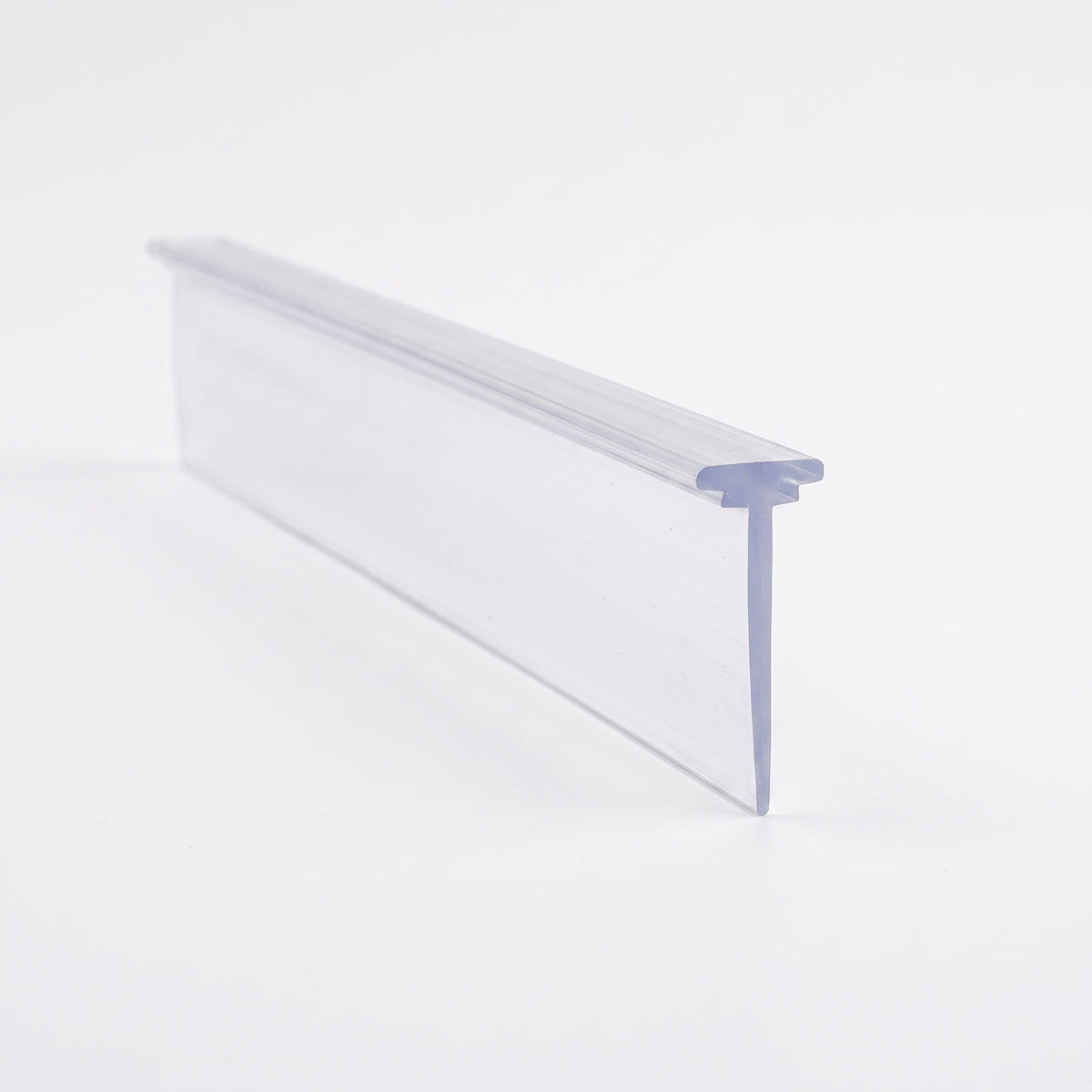 Clear seal length lying angled on white, small T-foot running along the edge of a long flat blade