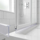 Clear blade seal fitted along a bifold door rail on a white tray, with a loose offcut in the foreground