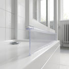 Tall clear blade seal hanging from a white folding screen rail onto a white bath, radiator behind