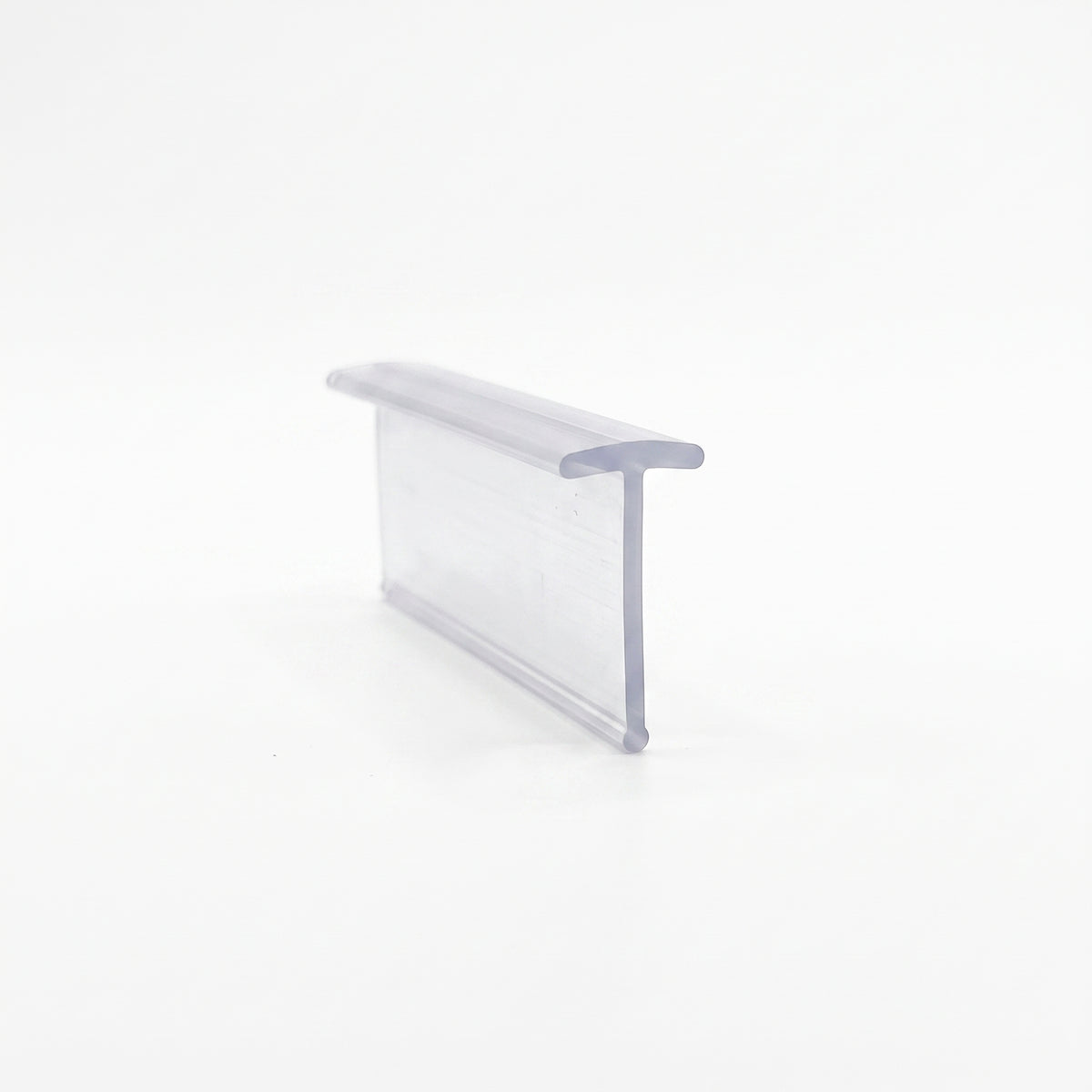 Clear seal offcut on white at an angle, flat T-cap running along the top of a tall straight blade
