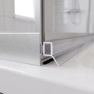 Clear push-in seal with ribbed foot in a bifold door bottom rail recess, blade sealing to the tray