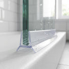 Clear seal gripped onto the bottom edge of 8-10mm frameless glass, sealing a 1-4mm gap to the tray