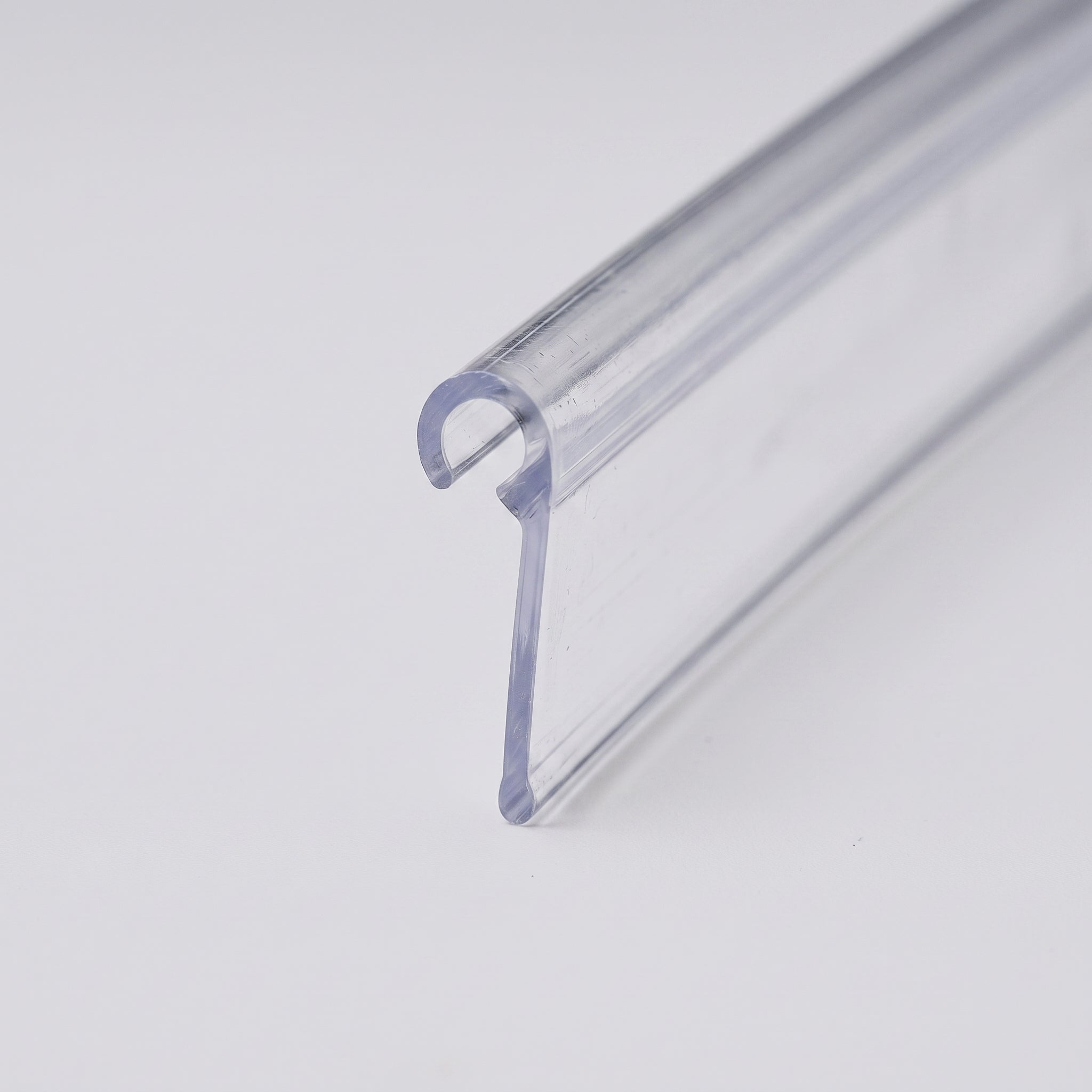 Clear rigid PVC hook-over seal profile - curled 6.5mm hook with 3mm opening and 34mm sealing blade