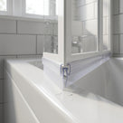 Clear rigid seal capped over the T-shaped ridge on a bifold bath screen bottom rail