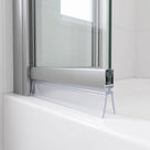 Clear tent-shaped seal splaying beneath the silver bottom rail of a bath screen, on a white bath