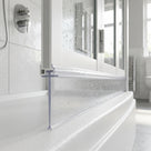 Very tall clear blade seal under a white bath screen rail, dropping onto a curved white bath edge