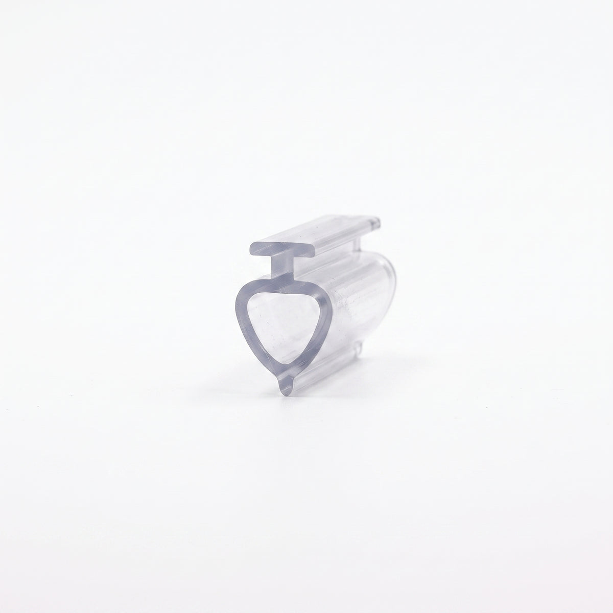 Clear seal offcut angled on white, T-head above a hollow teardrop loop tapering to a point