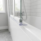 Clear seal with a wide flat wedge blade under a bath screen, lying on the white bath rim