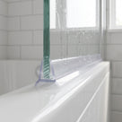 Clear seal gripped onto the bottom edge of 4-6mm frameless glass on a bath screen, sealing a small gap to the bath