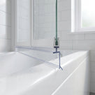 Clear bifold shower screen seal with 5mm T spine fitted along the bottom of a bath screen, blade sealing against the bath rim