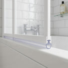 Clear seal with a small hollow tub section under a white bath screen rail, on a white bath