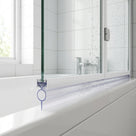 Clear seal with a round bubble ring under a white bath screen rail, outlined in blue on the bath