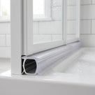 Clear push-in bifold shower seal fitted into a 9-11mm recess on the bottom rail of a shower door
