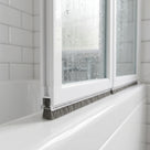 Brush seal with 6mm T backing and 6mm bristles fitted in the bottom channel of a bifold bath screen