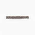 One cut length of brush seal side-on on white, white woven backing under a dense grey bristle pile