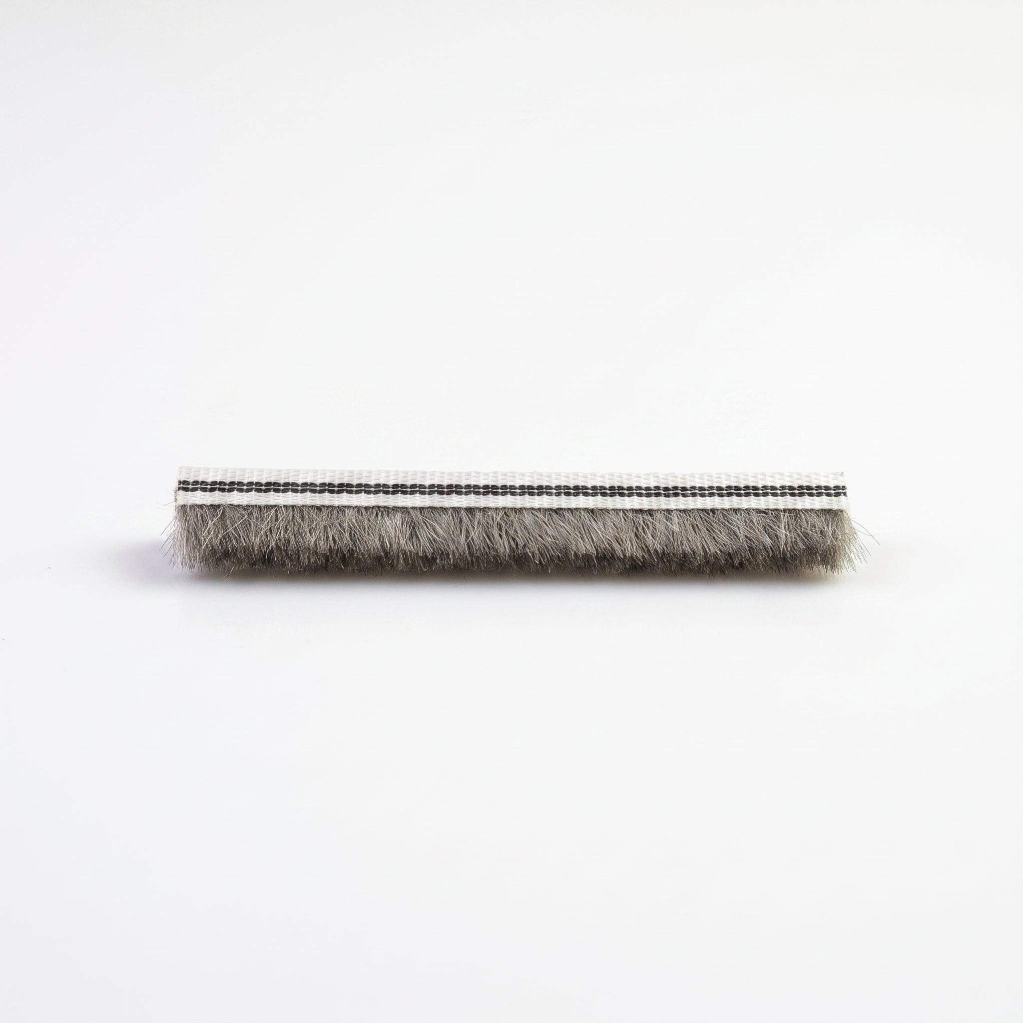 Cut length of BRUSH006 brush seal - white 6mm woven backing carrier with dense grey 8mm bristle pile