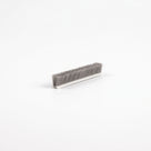 Short brush seal length angled on white, wide white backing with dense upright grey bristles