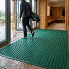 Holly green carpet insert entrance matting surface-laid with ramped edging inside a golf clubhouse entrance