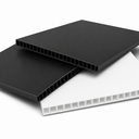 Black and white fluted sheets stacked on white, hollow flutes open along the cut edges