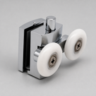 Chrome twin wheel shower door roller at an angle, showing the glass clamp, adjuster pin and two white nylon wheels