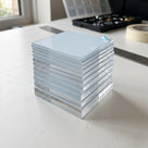 Stack of A4 acrylic sheets in stepped thicknesses, blue film on top, beside a steel rule and masking tape