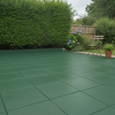 Dark green anti-slip concrete floor and patio paint on a UK garden patio near hedging