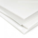Stacked corners of milky white polypropylene sheets on a white background, sawn edges to the front
