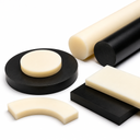 Ivory and black nylon stock on white - round bars, discs, a curved segment and rectangular plates