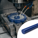 Blue acetal gear being machined under flood coolant in a CNC mill, inset of the blue rod