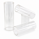 Four colourless clear acrylic tube offcuts, one standing upright and three lying angled, on a white studio background.
