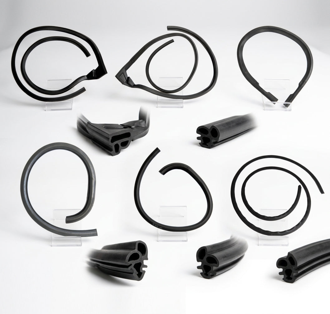 Flat lay of several coiled black rubber E-Type door and window seals on stands