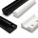 Black and white HDPE rods above a black chain-guide profile and a drilled white machined block