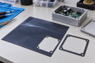 Illustrative electronics gasket prototyping with black conductive silicone sheet, 200 × 200mm